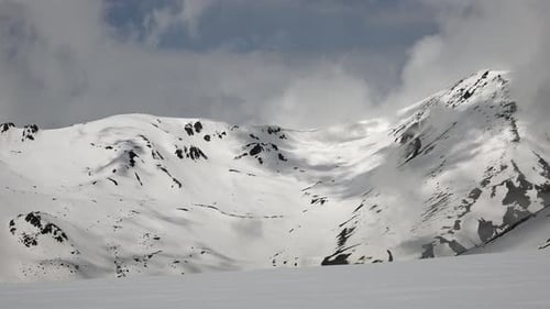 High Altitude Rocky Snowy Mountain Ridge in Sunny Day