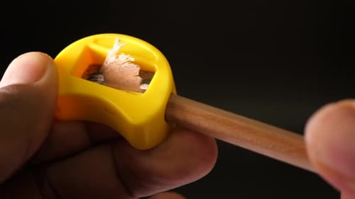 Sharpening Pencil With Yellow Hand Held Sharpener