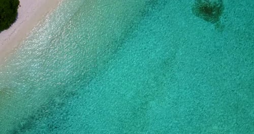 Wide angle above abstract view of a white paradise beach and aqua blue water background in vibrant