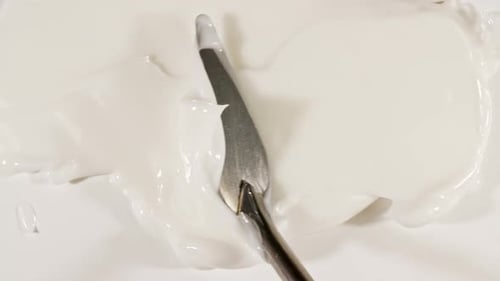 Spreading White Cream with Metal Spatula