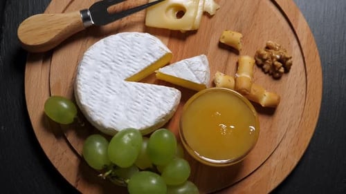 Cheese Board with Brie, Swiss, Grapes and Walnuts