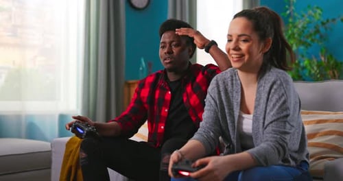 Friends Playing Video Games on Couch at Home
