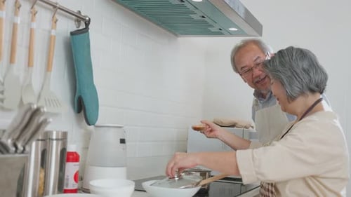 Senior Couple Cooking Together in a Bright Kitchen