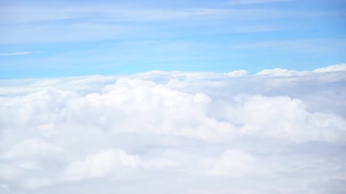 Aerial View Above Clouds in Bright Blue Sky