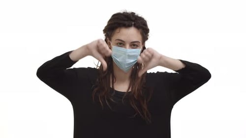 Woman Wearing Mask Giving Thumbs Up and Down