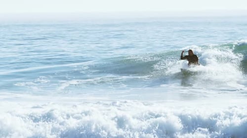 Surfers surfing in sea