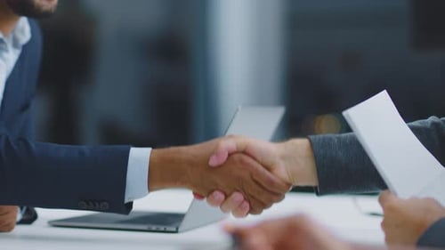 Business Professionals Shaking Hands Over a Table