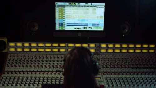 Unrecognizable Sound Engineer Touching Soundboard in Recording Music