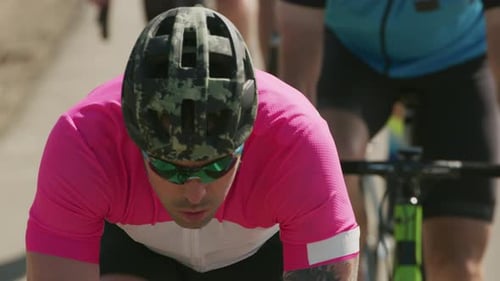 Tracking shot of a group of cyclists on country road. Fully released for commercial use.