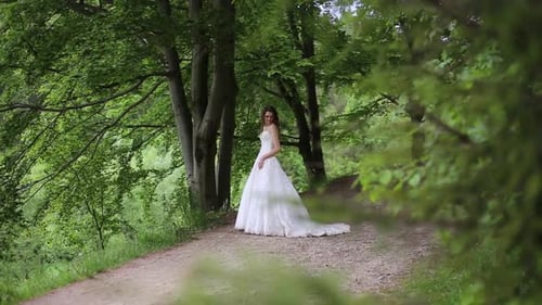 Woman in Wedding Gown Posing in Forest