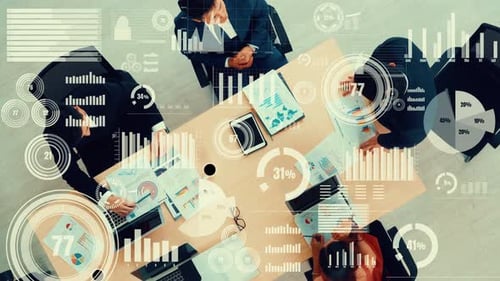 Overhead View of Business Meeting with Data Graphics