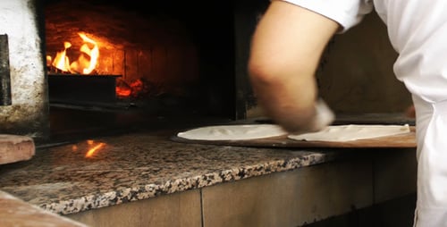 Adding Turkish Pizza Inside The Oven