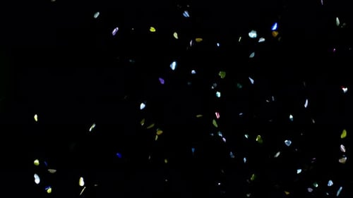 Colorful Confetti Falling on Black Backdrop