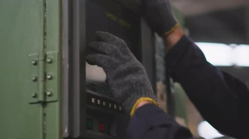 Close up technician hands adjust and control the machine by press on monitor in the factory area