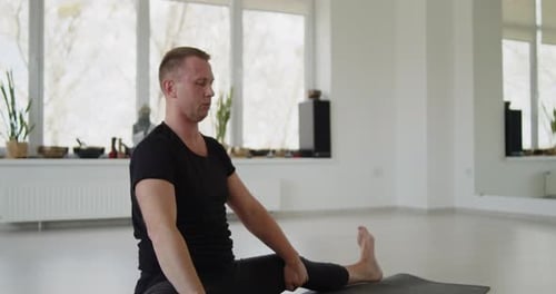 Adult Male Performing Yoga Stretch in Studio