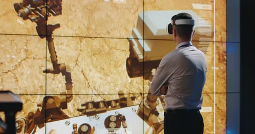 Man Using VR Headset to Explore Mars Rover