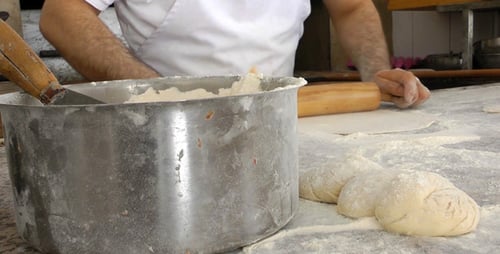 Baker Making Pitas With Roller 2