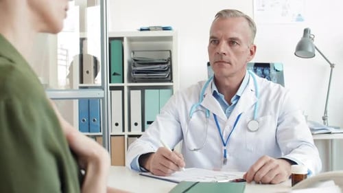 Doctor Consulting with Patient in Medical Office