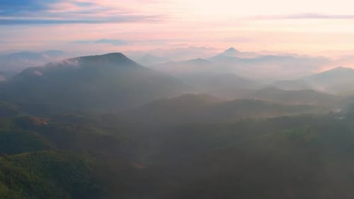 4K Flying through the clouds above mountain tops