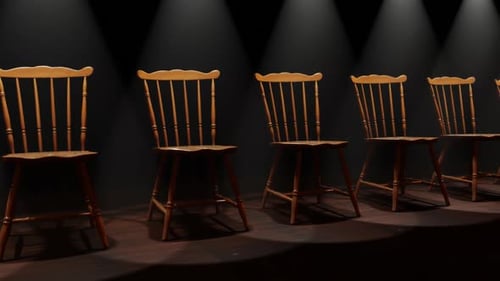 Empty Wooden Chairs on Stage with Spotlights