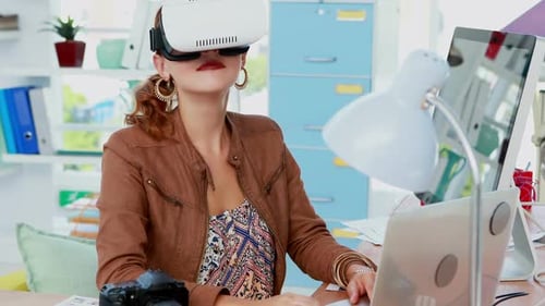 Woman Using Virtual Reality Headset at Desk