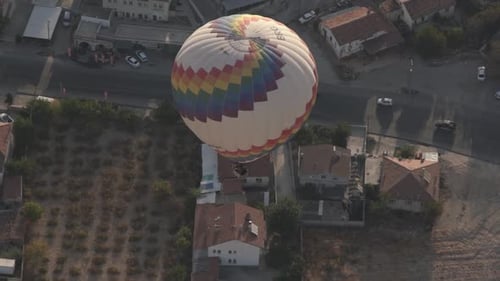 Hot Air Balloon Floating Over Homes from Above