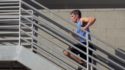 Man Running Up Outdoor City Stairs for Fitness
