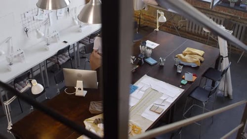 Fashion Designer Sketching Designs in Bright Studio