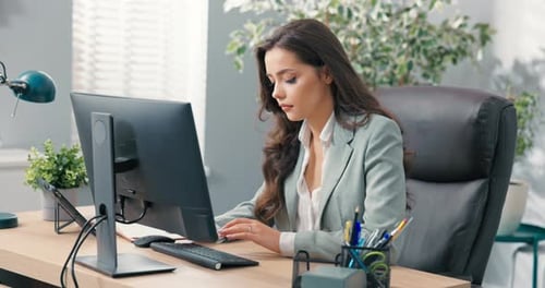 Pretty Hardworking Secretary of Company Assistant to Boss Manager Sits at Desk in Office in Front of