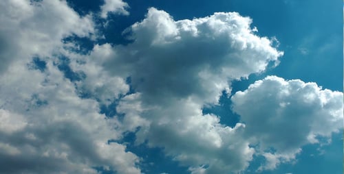 Clouds Moving Across Blue Sky on Sunny Day