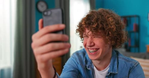Teen Smiling While on a Phone Video Call