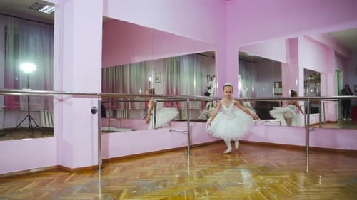 Slow motion. Professional ballerina perform pirouette in the ballet hall. A little dancer.
