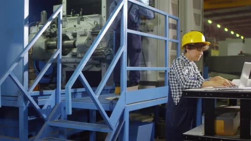 Female Technician at Factory Production Line
