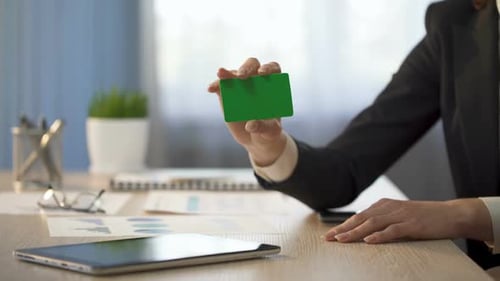 Businesswoman Showing Business Card With Green Field, Banking Services Ad