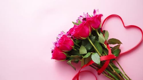 Pink Roses Bouquet with Ribbon Heart on Pink Background