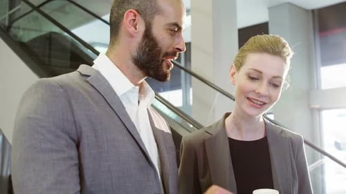 Business Colleagues Collaborate Using a Tablet in Modern Office