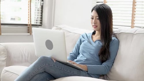 Young Woman Working on Laptop at Home