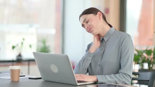 Young Woman Experiencing Neck Pain While Working