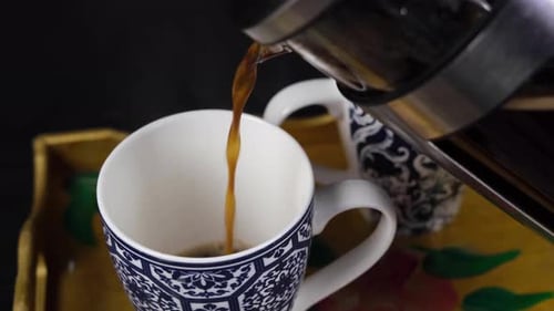Pouring Coffee into a Decorative Mug
