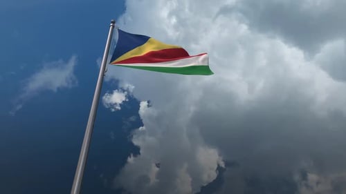 Seychelles Flag Waving on Pole Against Clouded Sky