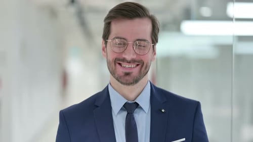 Smiling Man in Suit and Glasses