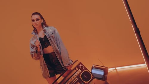 Woman Posing with Boombox in Fashion Studio