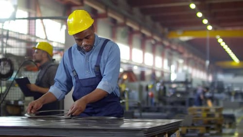 Contrôleur d'usine noir effectuant l'assurance qualité