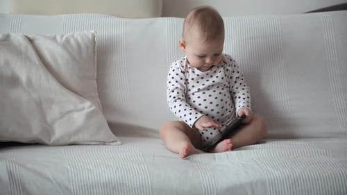 Baby Playing with Smartphone on Couch