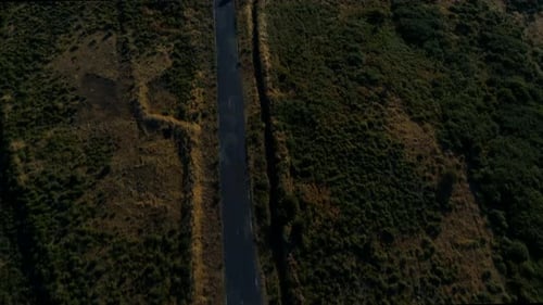 Empty Long Straight Road at Sunset Disappearing into the Horizon