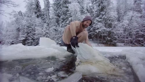 Man Removes Ice for Winter Lake Swimming