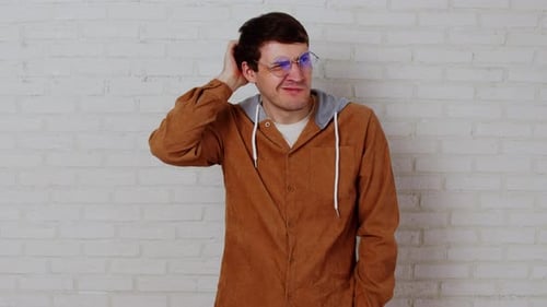 Young Adult Thinking and Scratching His Head