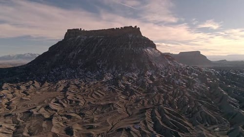 Flying through rugged desert terrain towards Factory Butte