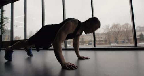 Man Doing Fast Pushups Exercise in Gym