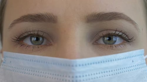 Woman's Eyes Wearing a Surgical Mask, Extreme Close Up